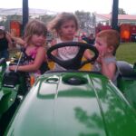 Kids on the tractors at the Great Lakes Radio Texaco Country Showdown