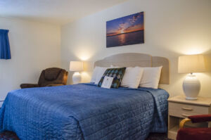 The king size bed with end tables and a gorgeous photo from Lake Superior above the bed