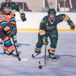 A NMU player moves the puck back down the ice into the Mutineers zone.